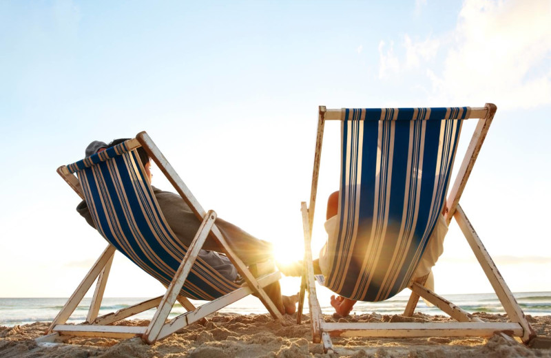 Relaxing by the beach near The Chateau Inn & Suites.