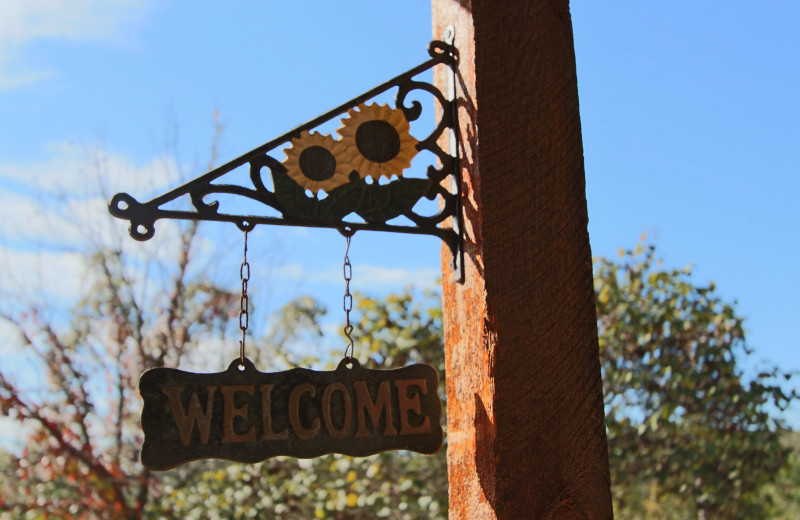 Welcome sign at Ozark Cabins.