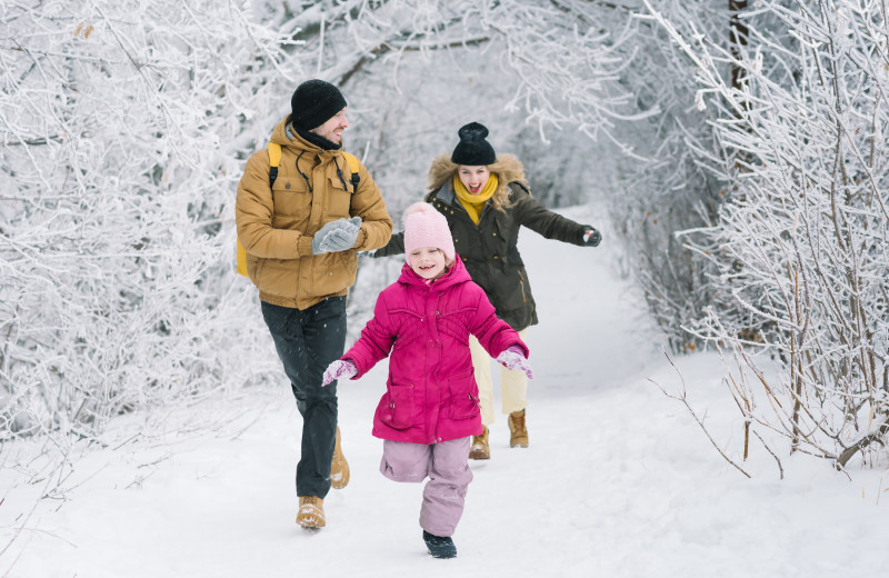 Family running through snow at GO-Cottage.