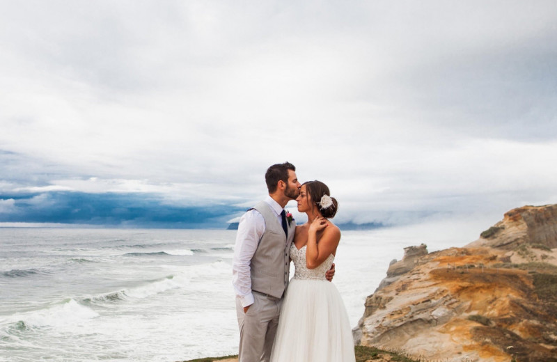 Wedding couple on beach at Inn at Cape Kiwanda.