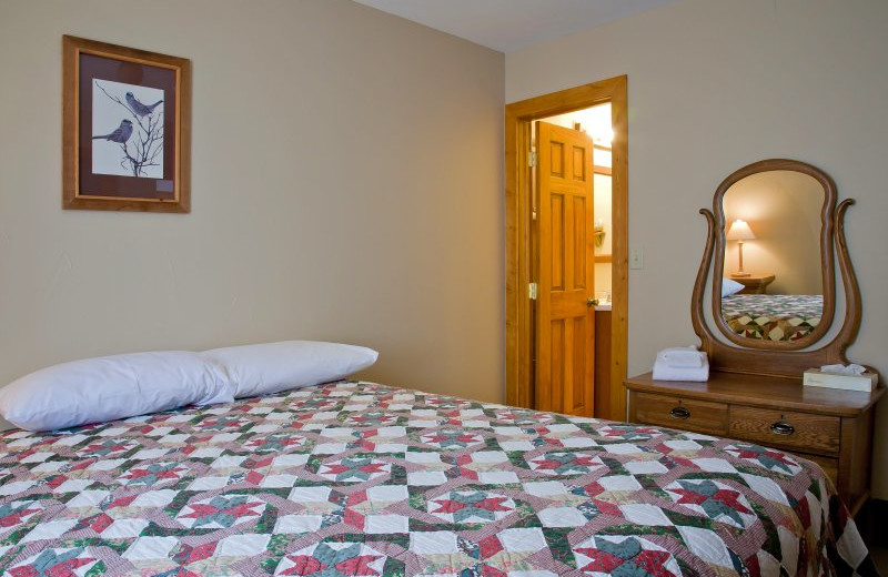 Cabin bedroom at Sylvan Dale Guest Ranch.