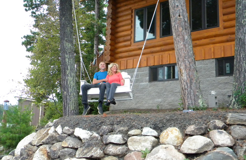 Couple on swing at Crane Lake Wilderness Lodge.