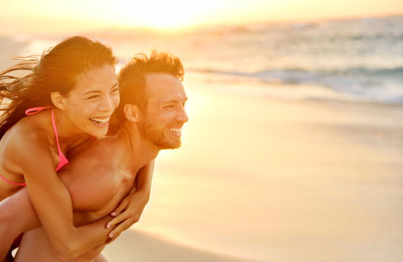 Couple on beach at Ocean Walk Hotel.