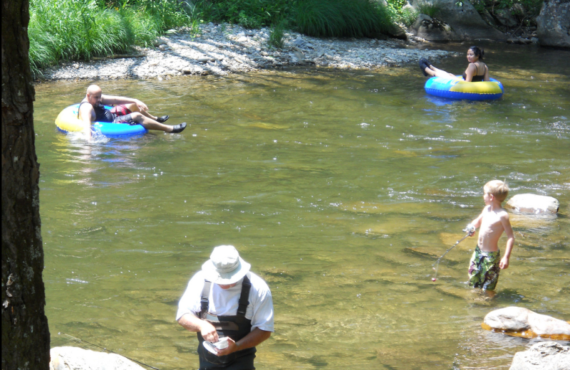 Fishing and tubing in the river at Yogi Bear's Jellystone Resort Cherokee.