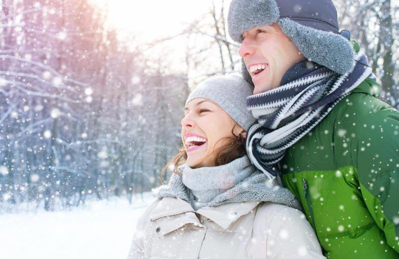Couple in snow at Bay Pointe Inn Lakefront Resort.