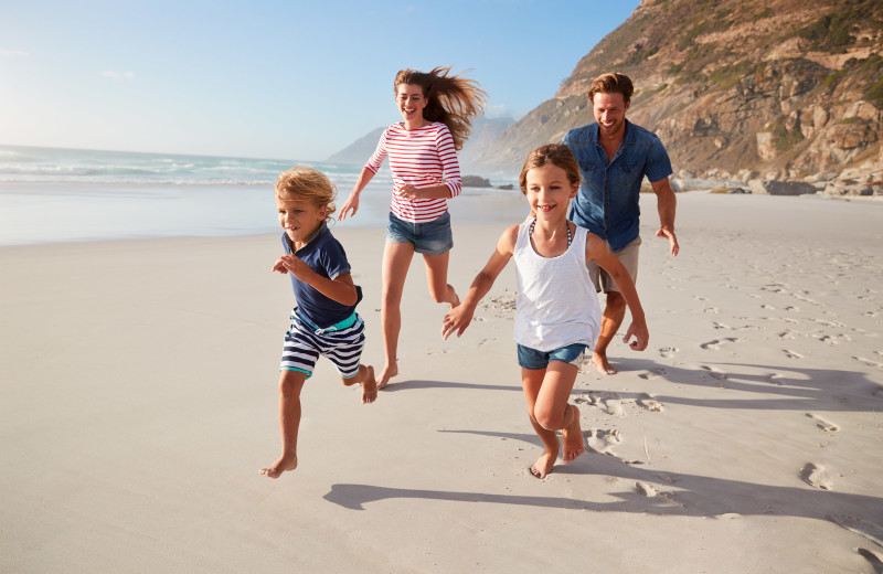 Family on beach at Cavalier Beachfront Condominiums.