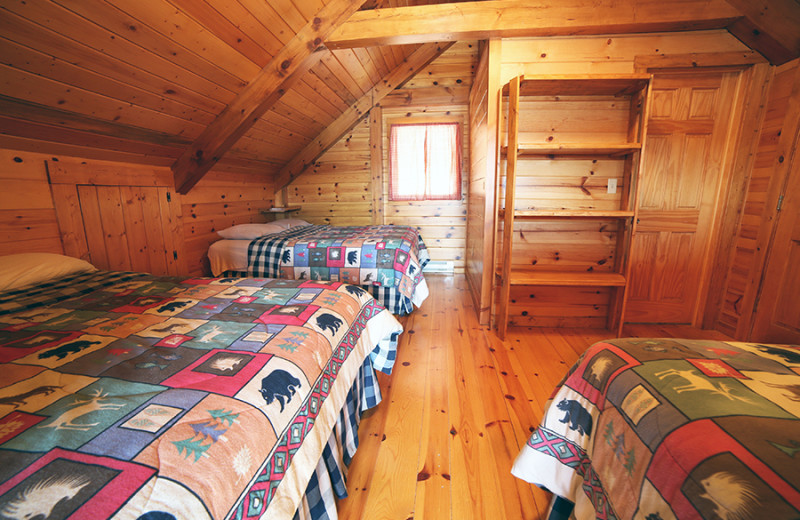 Cabin bedroom at Cliff Lake Resorts.