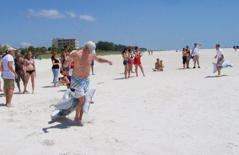 Family time on the beach at Gulf Winds Resort Condominiums.