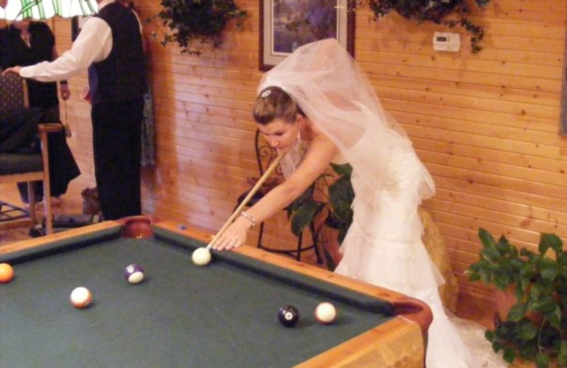 Bride playing pool at Harpole's Heartland Lodge.