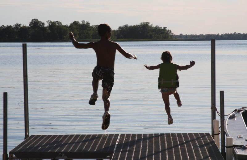 Kids jumping in lake at Deer Lake Resort.