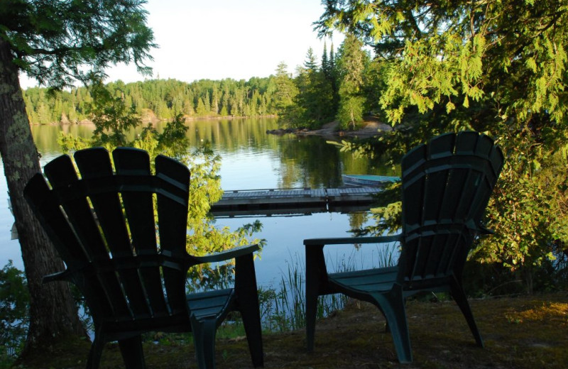 Chairs by lake at Rainbow Point Lodge.