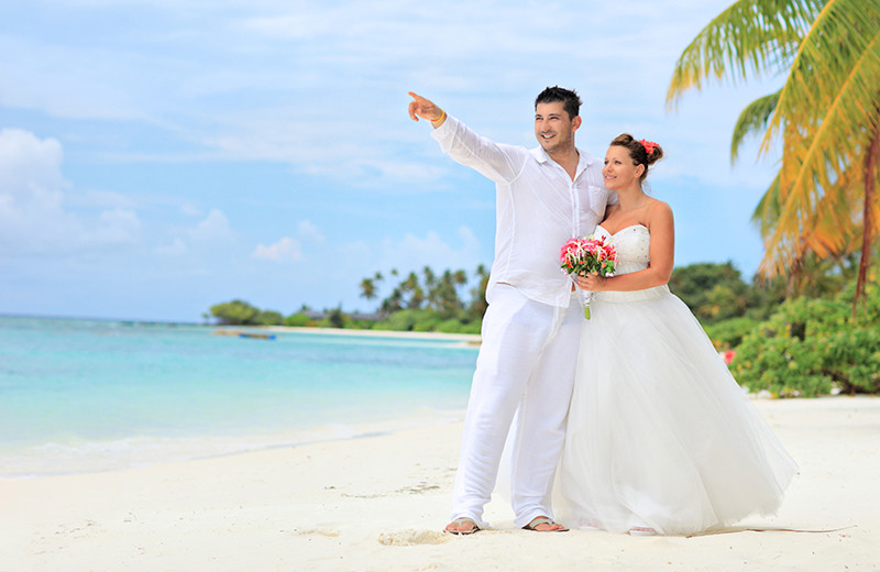 Couple on beach at The Plaza Suites.