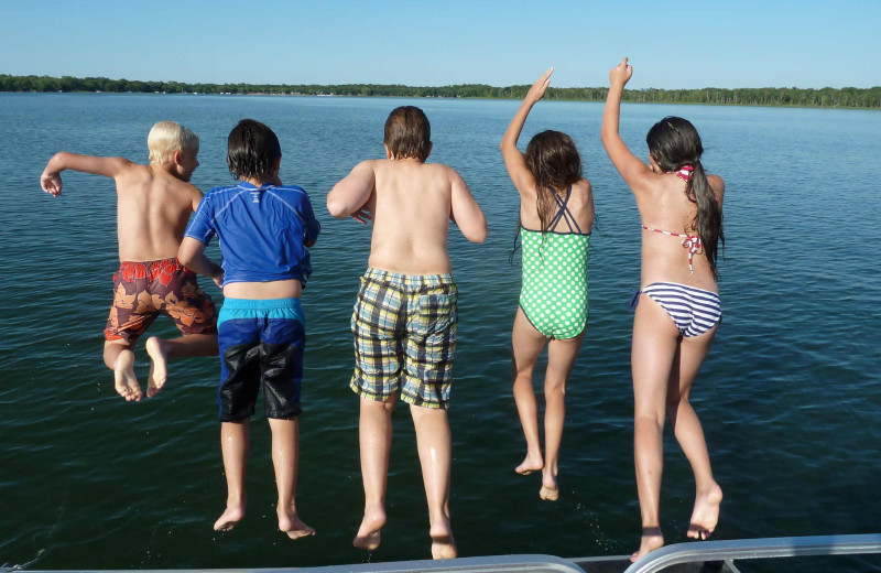 Kids jumping in lake at Woodlawn Resort.