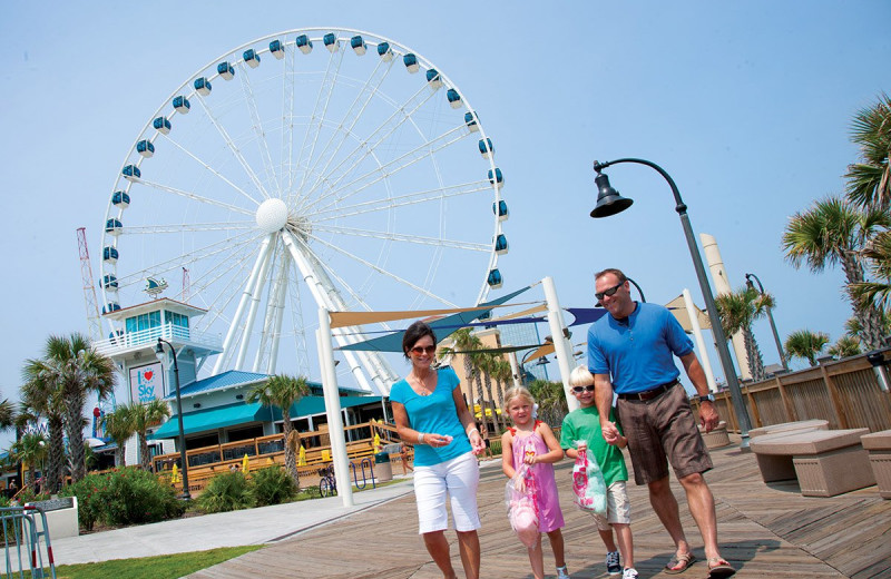 Family on boardwalk at The Strand Resort Myrtle Beach.