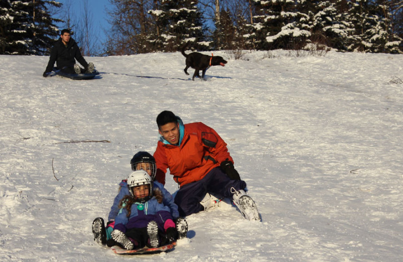 Family sledding at Salmon Catcher Lodge.