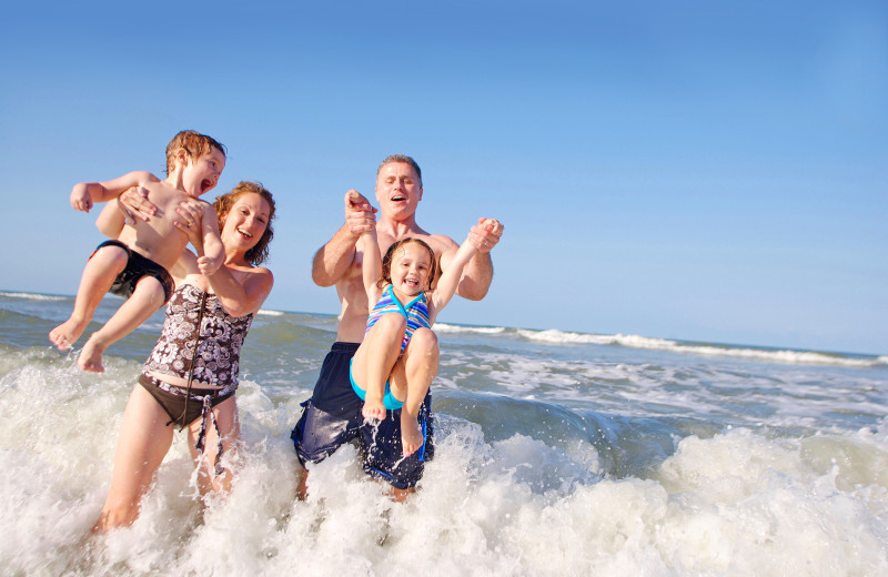 Family on beach at Bal Harbour Quarzo Luxury Boutique Hotel.