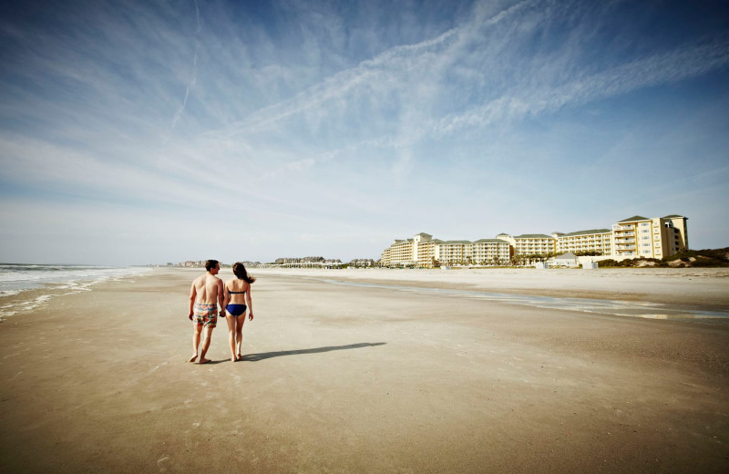 Couple walking on beach at Omni Amelia Island Plantation.