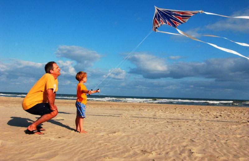 Father And Son Flying Kite at Hatteras Realty 