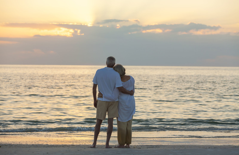 Couple on beach at VIP Vacation Rentals LLC.