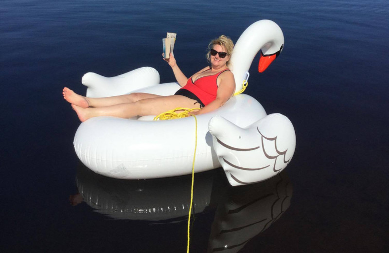 Relaxing on swan floatie on lake at Owls Nest Lodge.