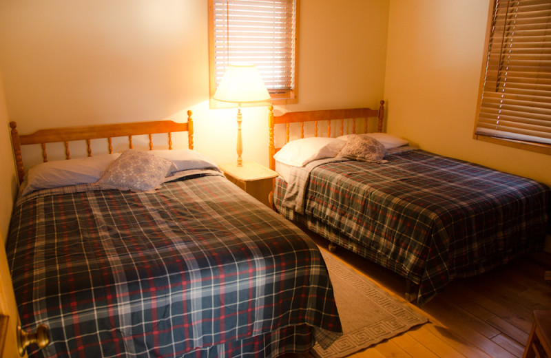 Cabin bedroom at Tri Lake Timbers Resort.