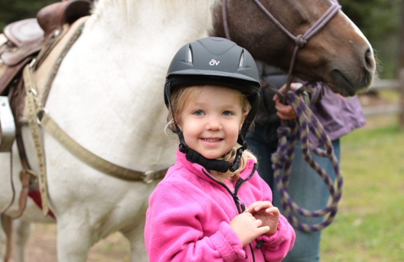 Kid and horse at Tumbling River Ranch.