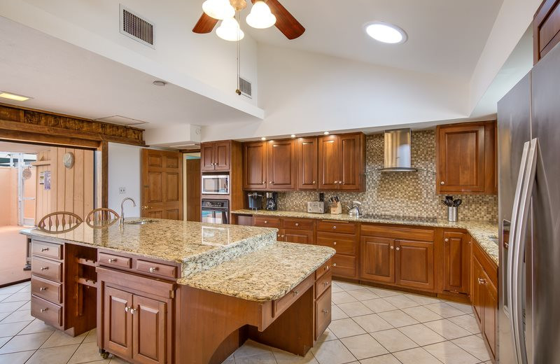 Rental kitchen at Sun Palace Vacation Rentals.