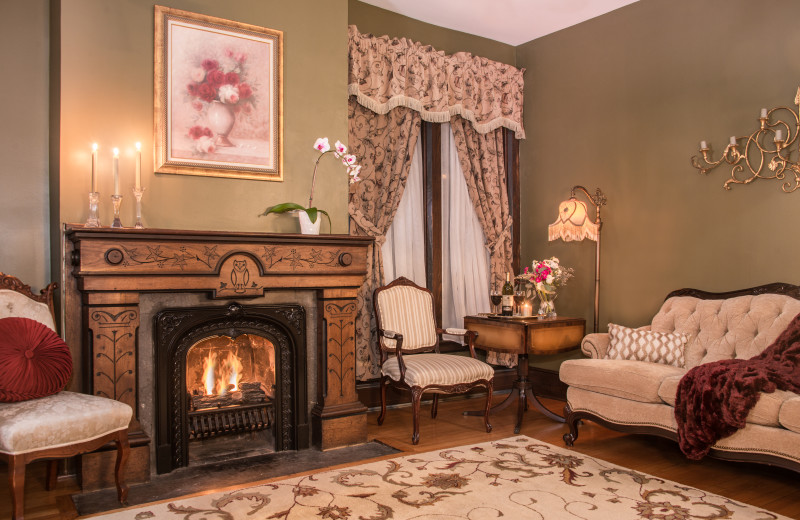 Part of the two-room Penfield Suite, the parlor boasts beautiful wood carvings on the fireplace.  It has a sofa, two wing back sitting chairs & tables to relax in your private haven.