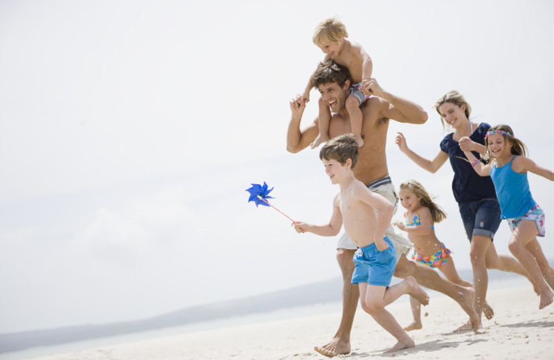 Family on beach at Moontide Motel, Cabins and Apartments.