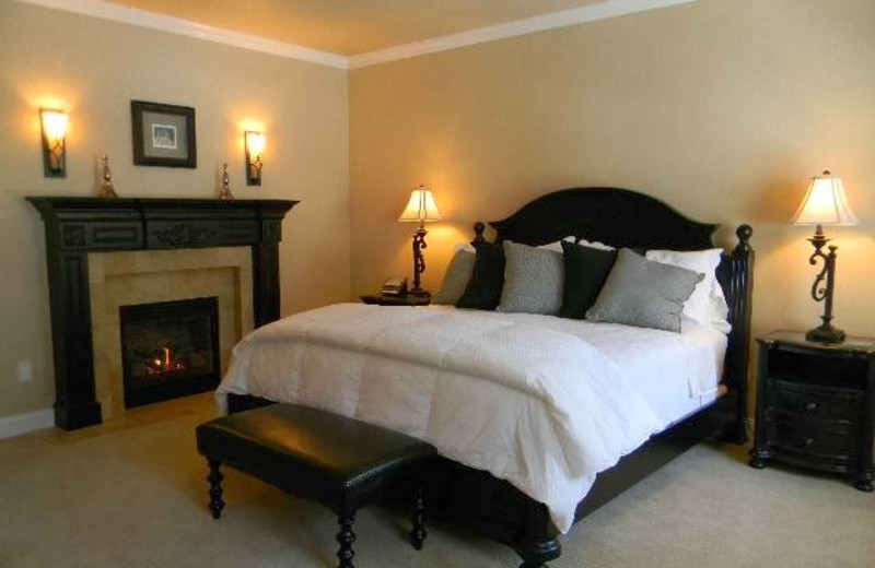 Guest bedroom with fireplace at Summer Creek Inn & Spa.