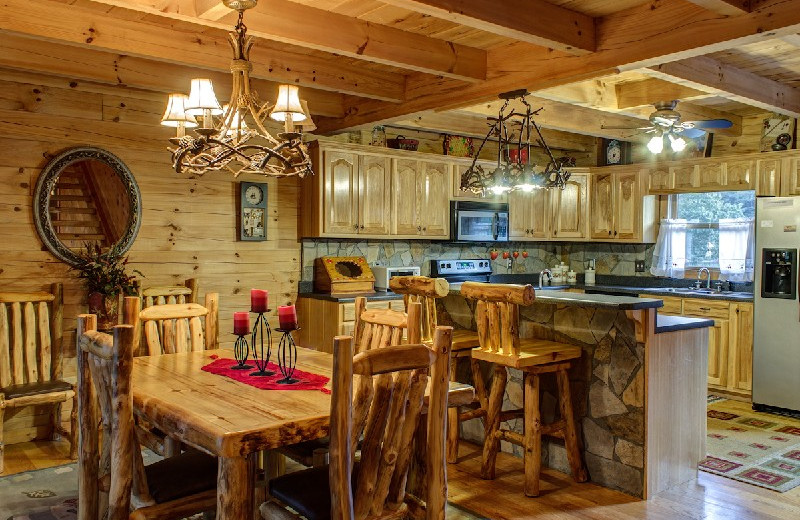 Cabin dining table and kitchen at Georgia Mountain Rentals.