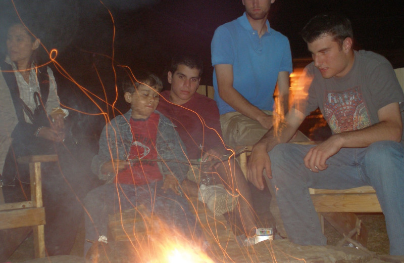 Family by campfire at August Lodge Cooperstown.