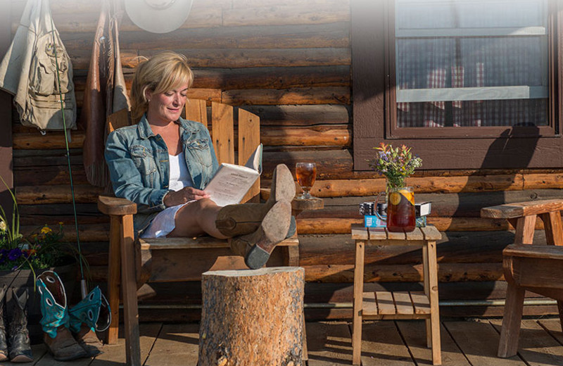 Sitting on porch at Triangle X Ranch.