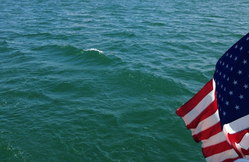 Lake and flag at Charlevoix Inn & Suites.