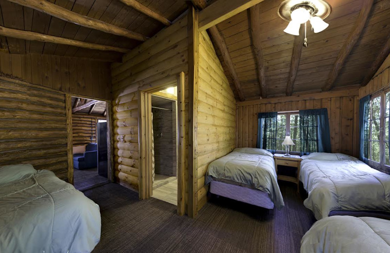 Cabin bedroom at Pere Marquette River Lodge.