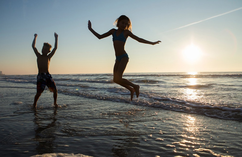 Jumping on the beach at Crown Reef Resort.