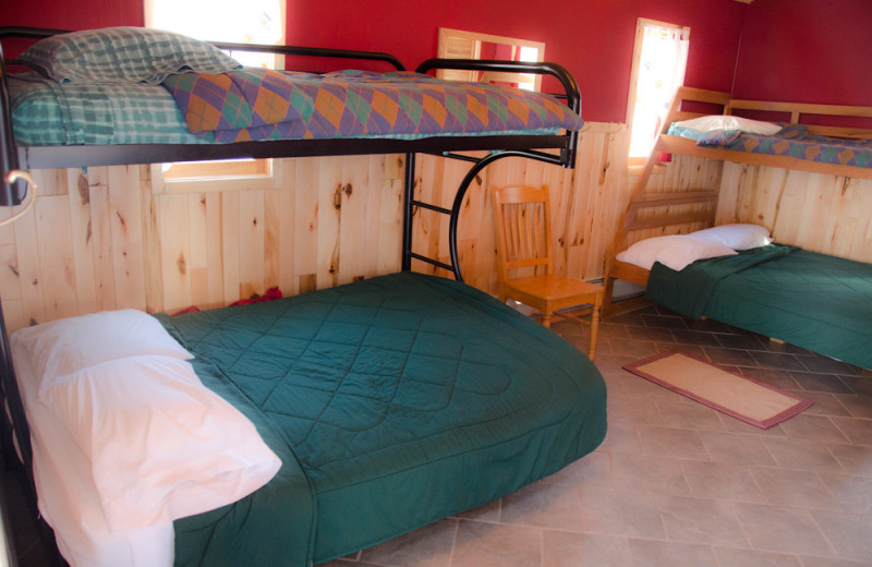 Cabin bedroom at Tri Lake Timbers Resort.