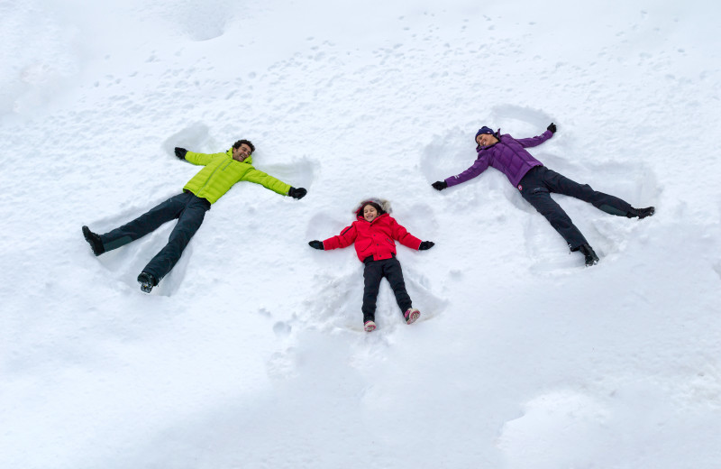 Kids making snow angels at Fairmont Le Chateau Montebello.