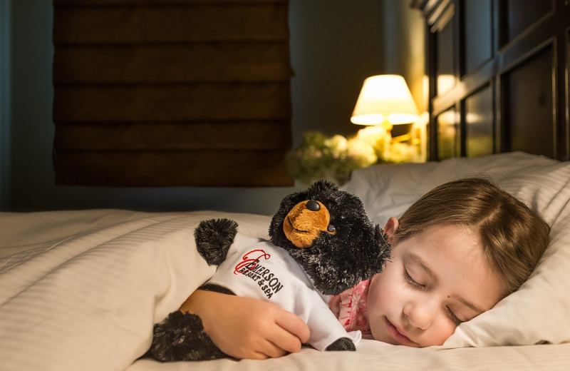 Kid sleeping in bed at Emerson Resort & Spa.