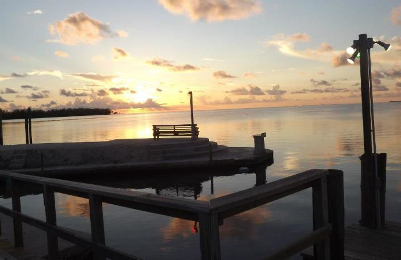 Bench on dock with ocean view at Coral Bay Resort.