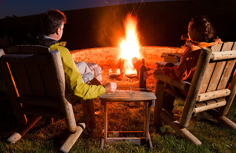 Couple by bonfire at Hungry Moose Bed and Breakfast.