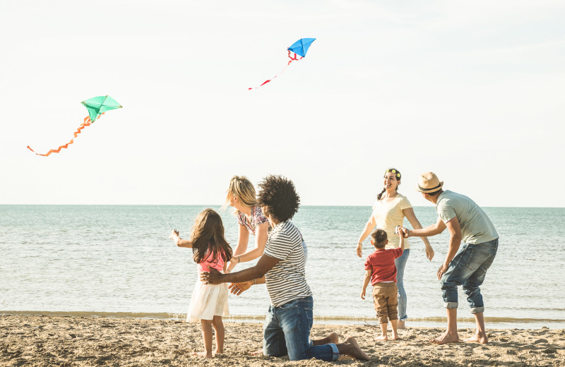 Family flying kites at Williamson Realty Vacations.