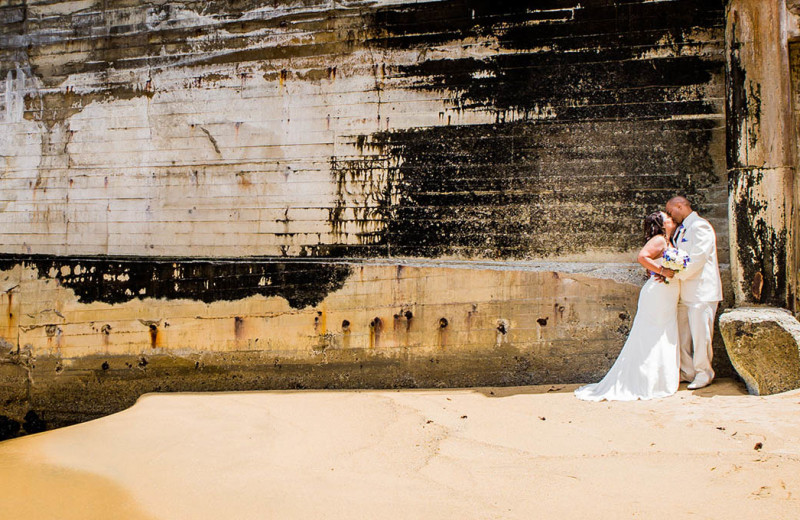 A beautiful couple standing in front of the historic Aeneas Cannery