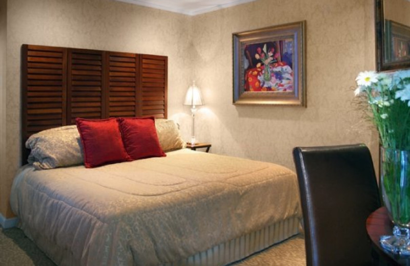 Guest bedroom at The Chateau Inn & Suites.