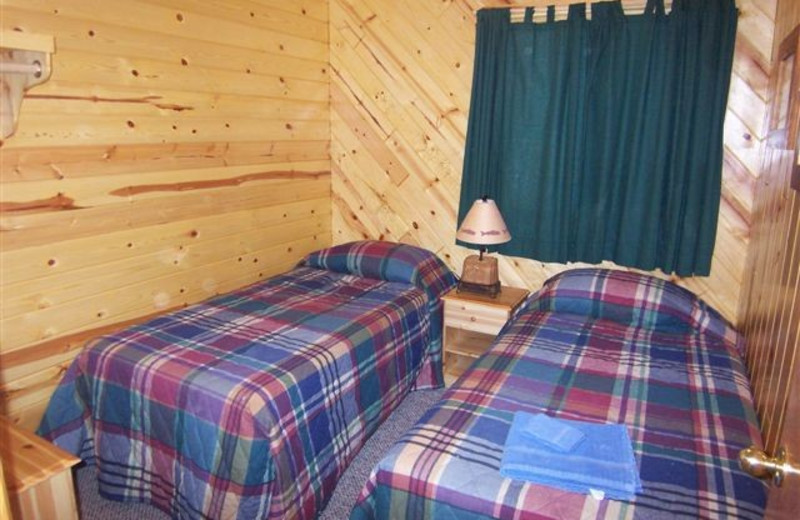 Cabin bedroom at Ash-Ka-Nam Resort.