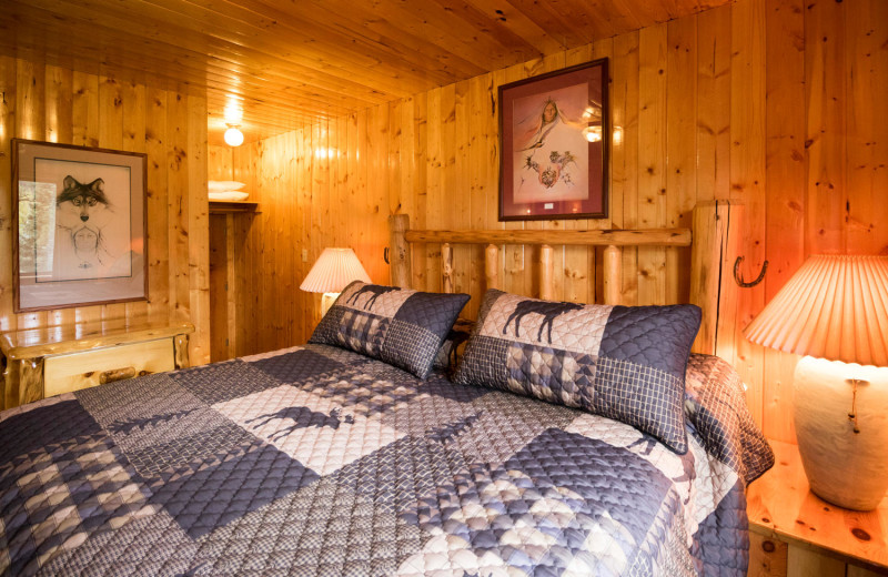 Cabin bedroom at Pine River Lodge.