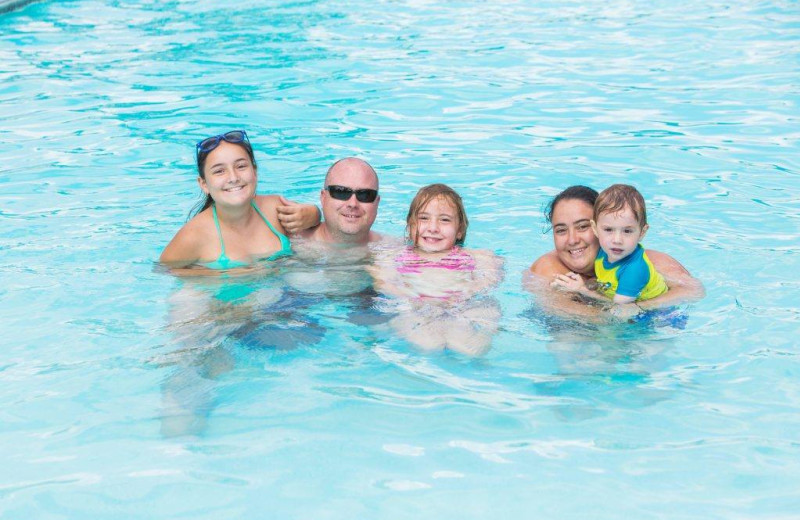 Family in pool at Great Blue Resorts- Woodland Estate Resort.