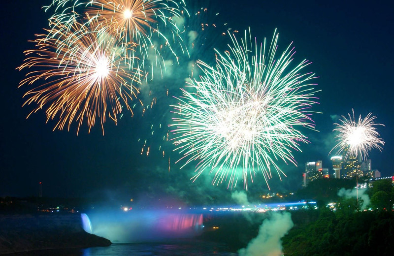 Fireworks over waterfall at DoubleTree Fallsview Resort & Spa by Hilton - Niagara Falls.