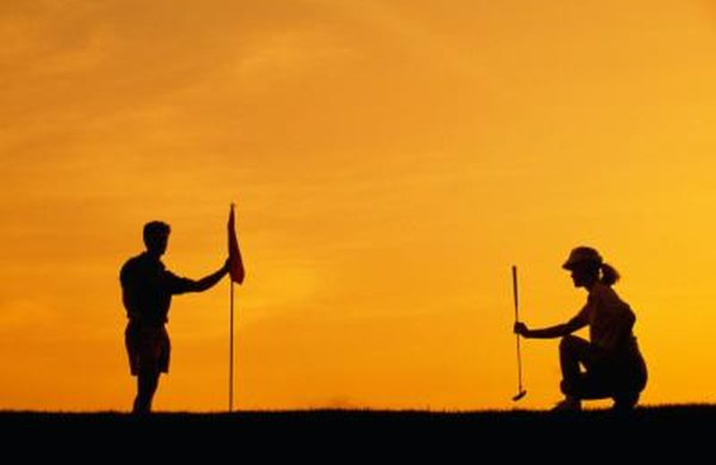 Couple playing golf near South Wind on the Ocean.