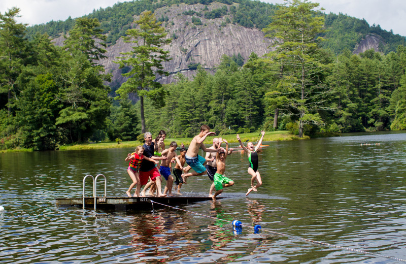 Kids jumping in lake at High Hampton Resort.